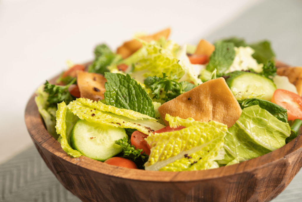 Wooden bowl filled with fattoush salad.