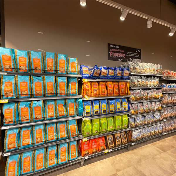 Shelves displaying Farm Boy Snacks - Tortilla Chips and popcorn. Grab these snacks at Farm Boy Metcalfe grocery store.