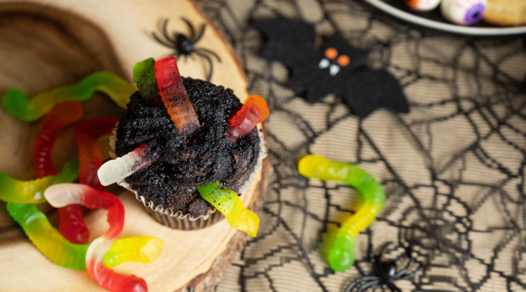 Halloween snacks: earthworm cupcakes with chocolate crumb and gummy worms