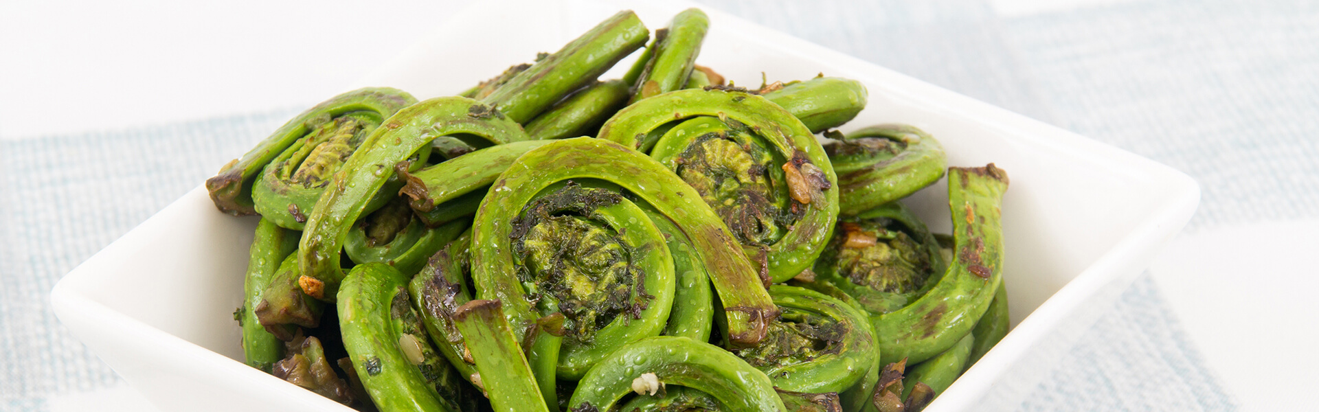 Cooked Fiddleheads with garlic.