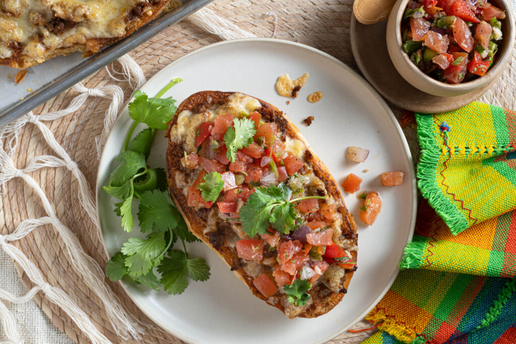 Overhead image of Mexican molletes made with refried beans, cheese, and pico de gallo