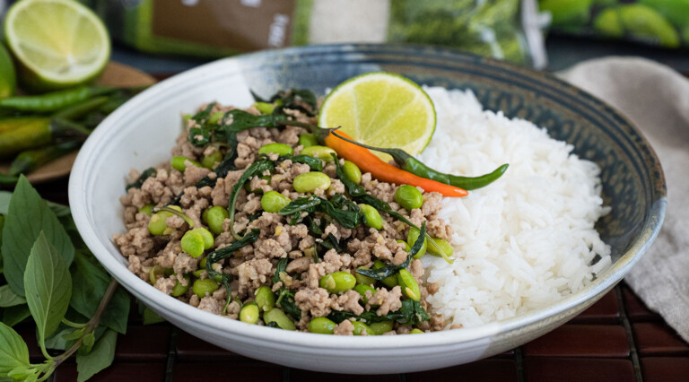 Thai Pork Basil Stir Fry served alongside Jasmine rice in a bowl.