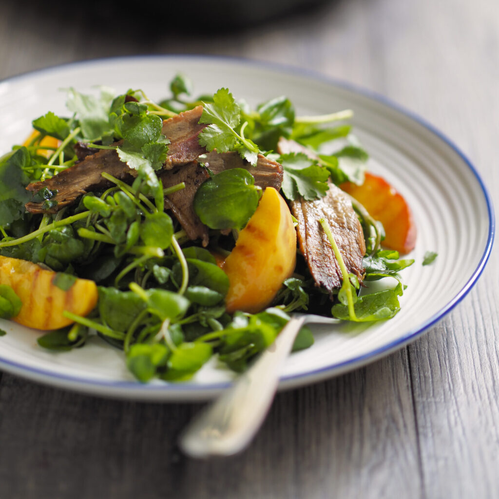 Watercress salad with duck and grilled peaches