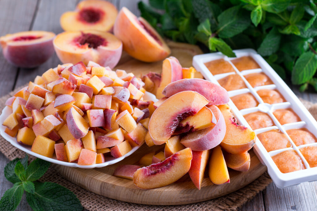 Frozen peaches, sliced, diced, and formed into ice cubes.