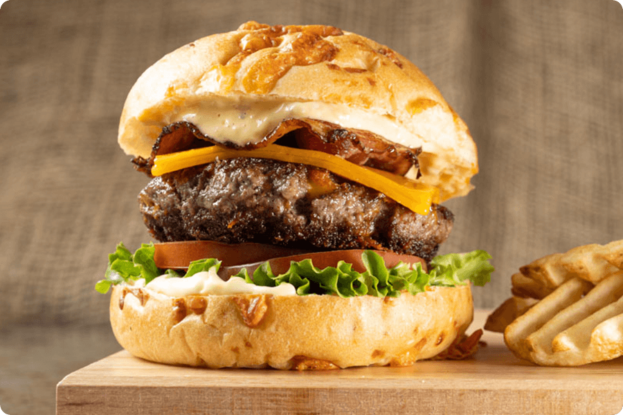 Indulge in the rich and savory delight of a Bacon Cheddar burger where the patty is crafted from fresh, high-quality steak. 