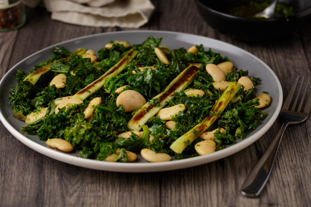 Healthy vegan kale, grilled leek, and white beans salad