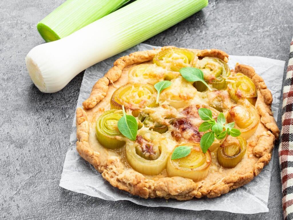 Leek and cheese tart on gray background