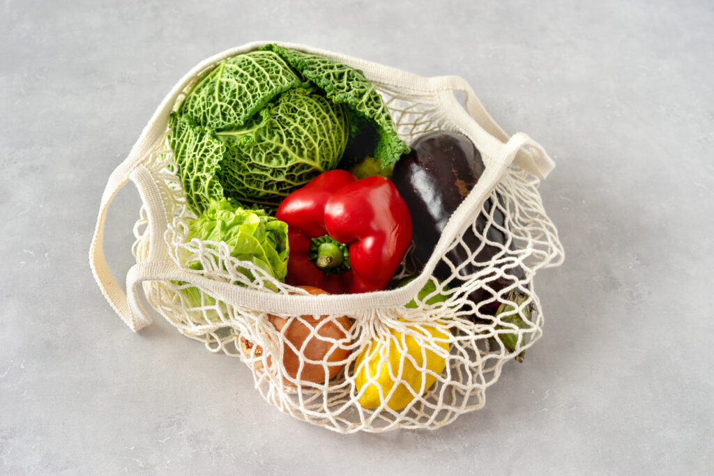 Mesh produce bag with veggies and fruits.