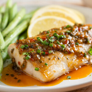 Zesty, Spicy Mahi Mahi plated along with green French beans and lemon wedges.