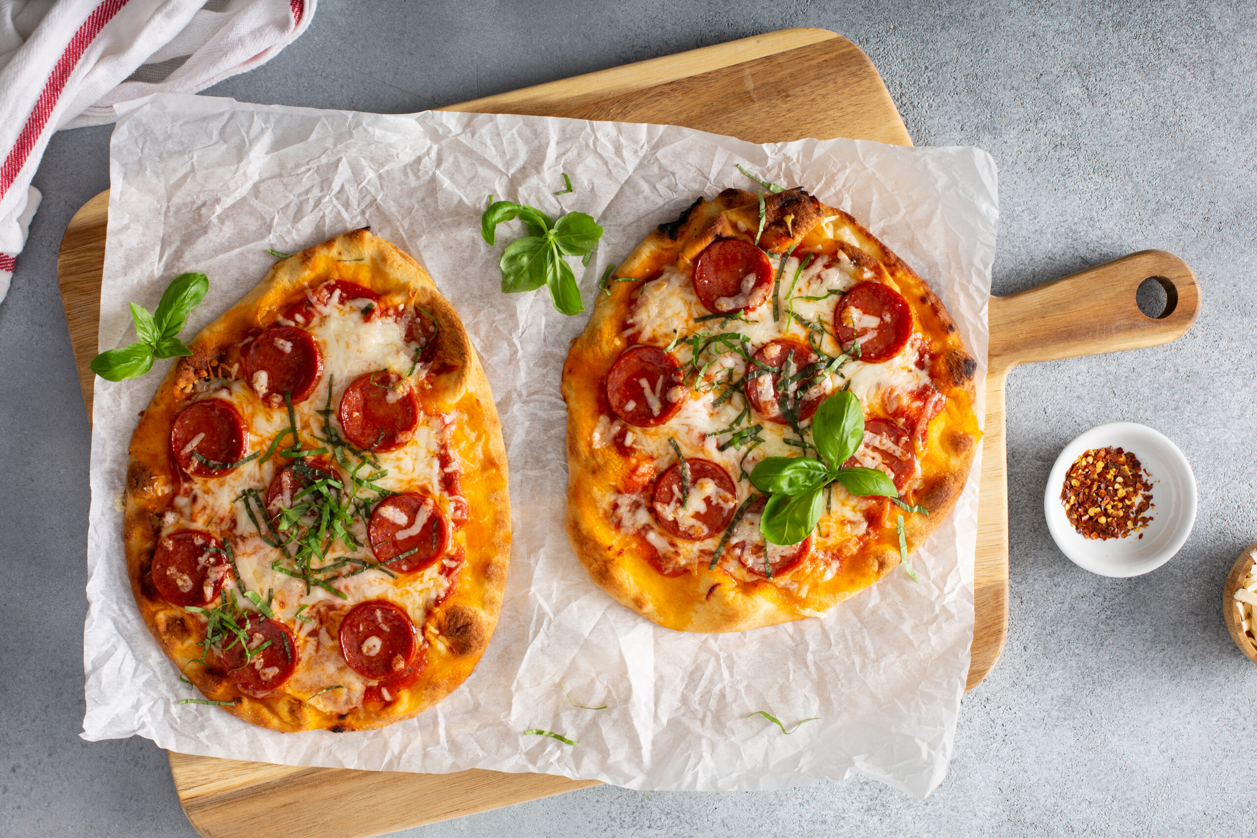 Naan pepperoni pizza with fresh basil.