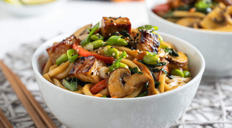 Quick weeknigh dinner - Teriyaki Tofu and Udon Noodle Stir Fry served in a bowl.