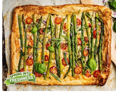 A rustic homestyle Tart made using the Farm Boy Butter Puff Pastry, tomatoes, asparagus, cheese, and basil leaves. 