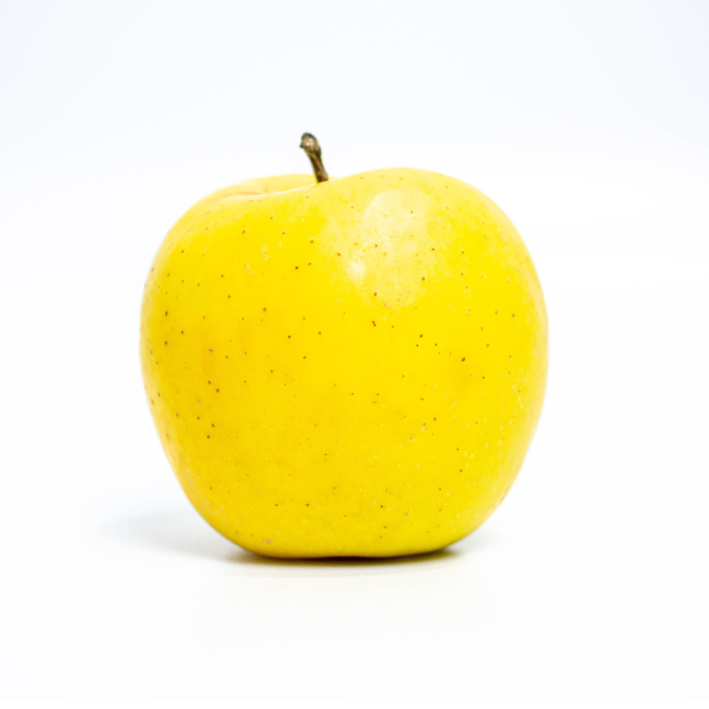 Golden Delicious apple on white background