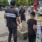 One Farm Boy employee points into a cooler so customers can grab a free drink.