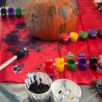 Close up of all types of paint used to create designs on a pumpkin.