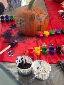Close up of all types of paint used to create designs on a pumpkin.