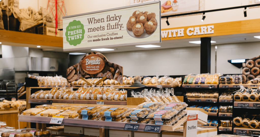 Sign hanging in a store talking about how our produce beats morning traffic getting into Farm Boy stores.