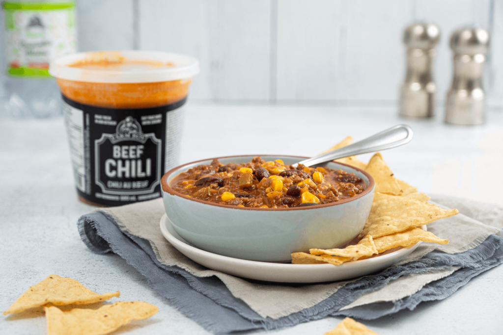 Bowl of Farm Boy Beef Chili with tortilla chips.
