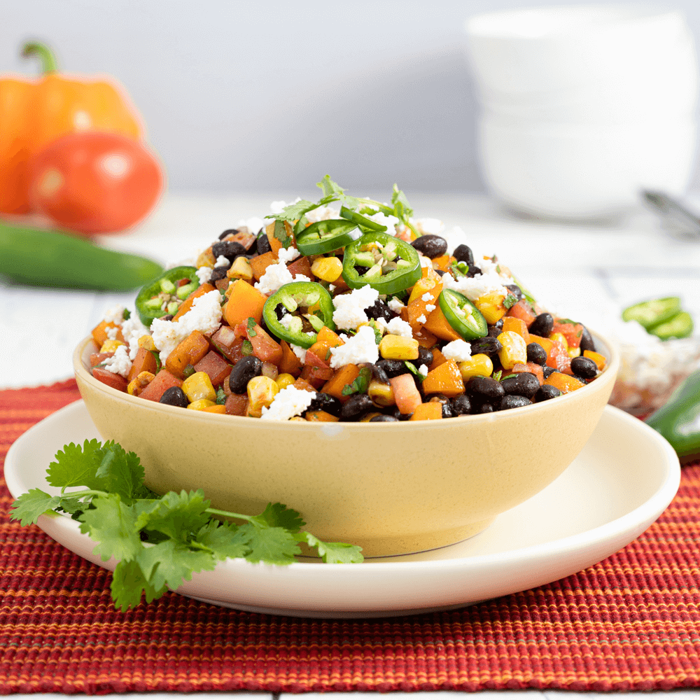 Mediterranean black bean salad with corn, tomatoes, and cheese.
