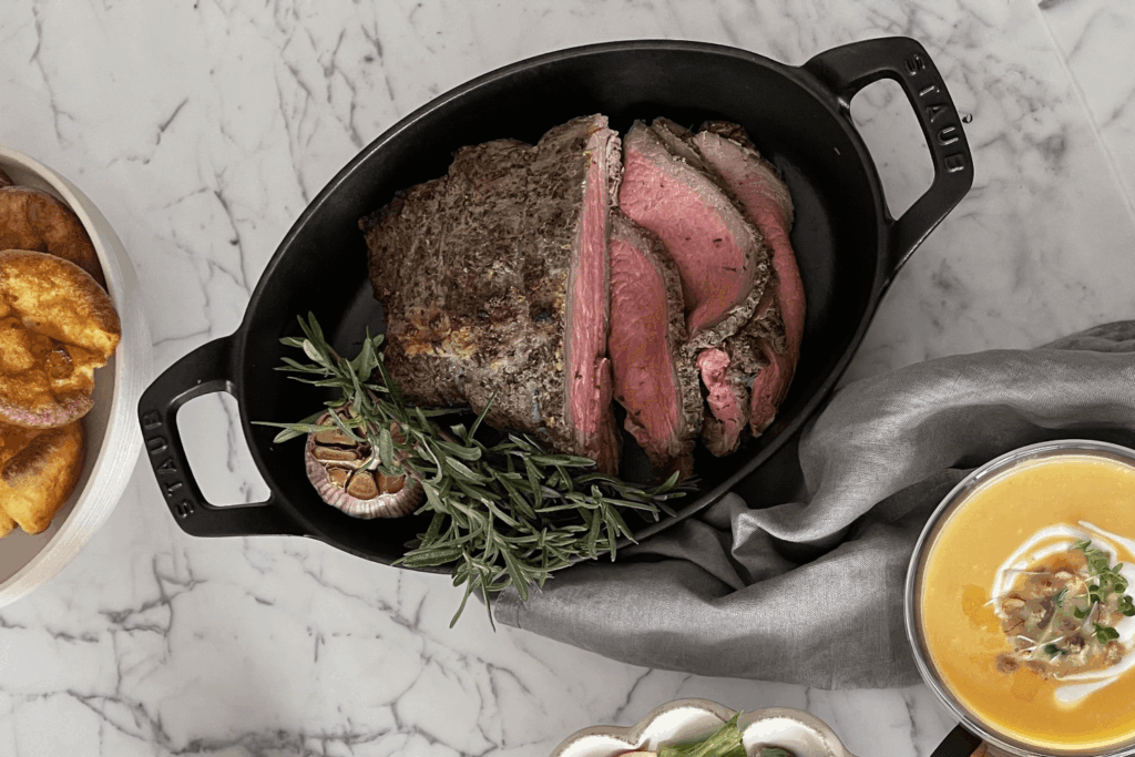 Cast iron pan with reverse sear beef roast with thyme sprigs