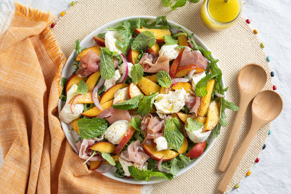 Overhead image of nectarine, prosciutto, and burrata salad