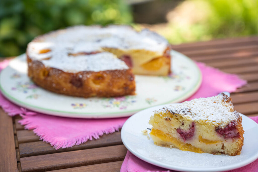 Slice of summer stone fruit coffee cake with slice removed
