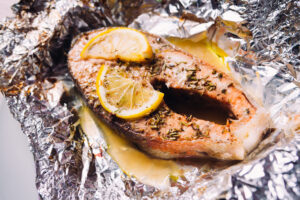 fish steak baked with lemon and herbs in foil