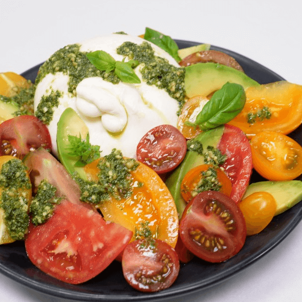 Tomato, Avocado, and burrata salad with pesto.