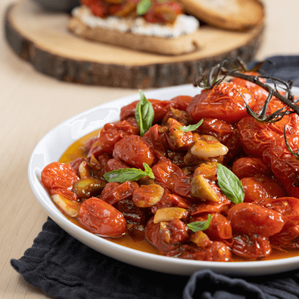 Plate of roasted tomatoes with olives and garlic