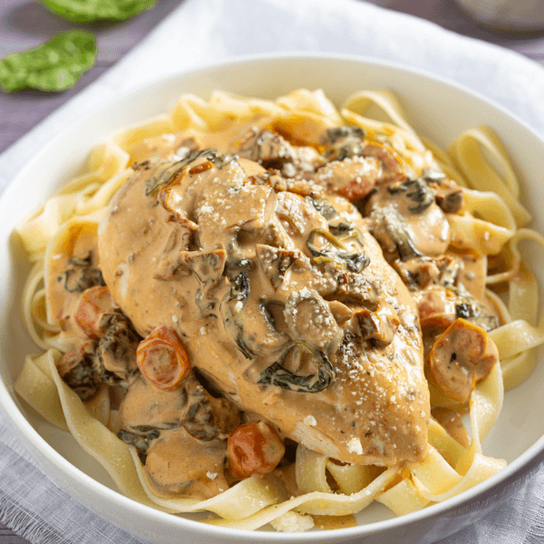 Chicken breast on noodles with creamy sauce