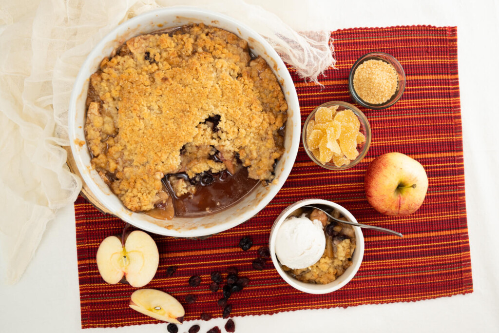 Overhead image of almond apple cranberry crumble with apples, crystallized ginger, and dried cranberries