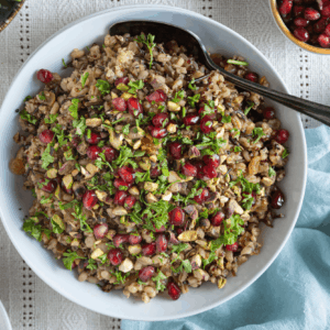 Overhead image of bowl of Jewelled Mixed Grain Pilaf with parsley, pistachios, and pomegranate arils