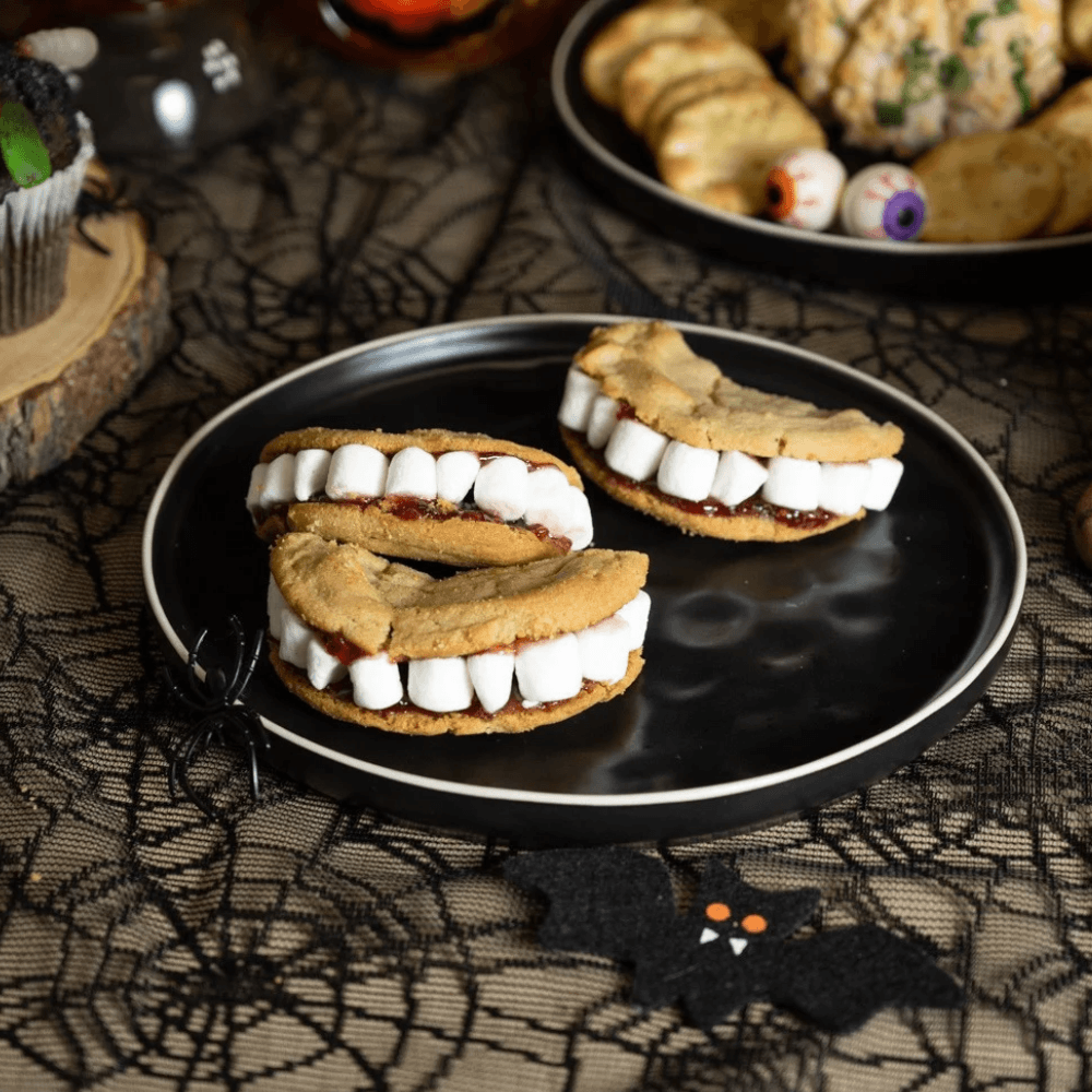 Three cookie sandwiches made to look like mouths with teeth for Halloween snack