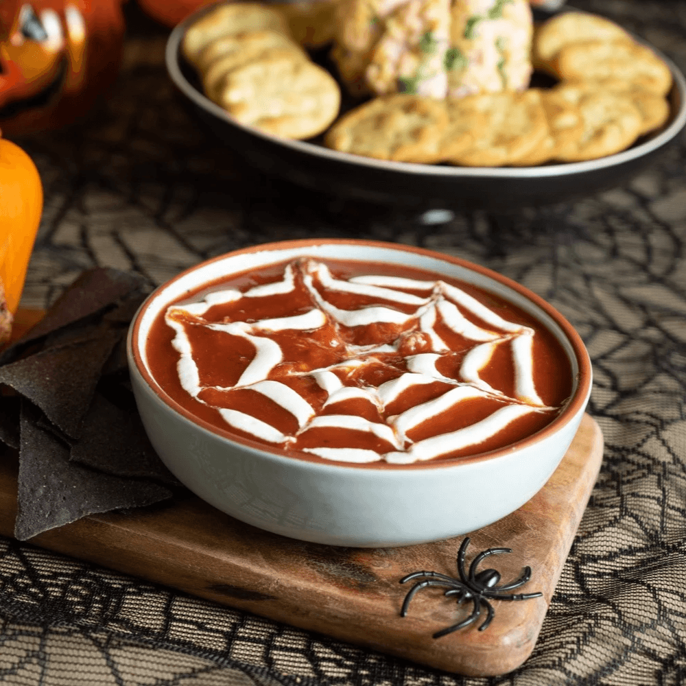 Bowl of dip with a piped cobweb design for Halloween