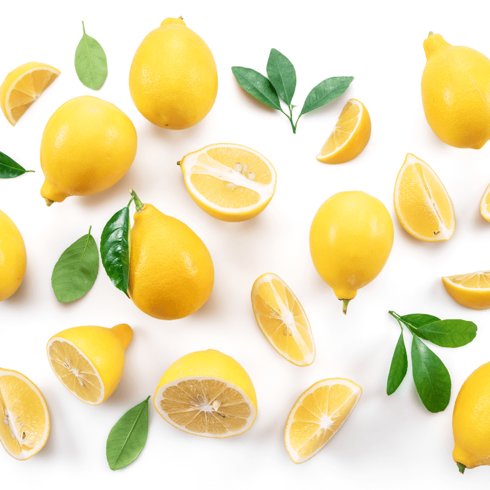 Whole and wedges of lemon and leaves on white bakckground