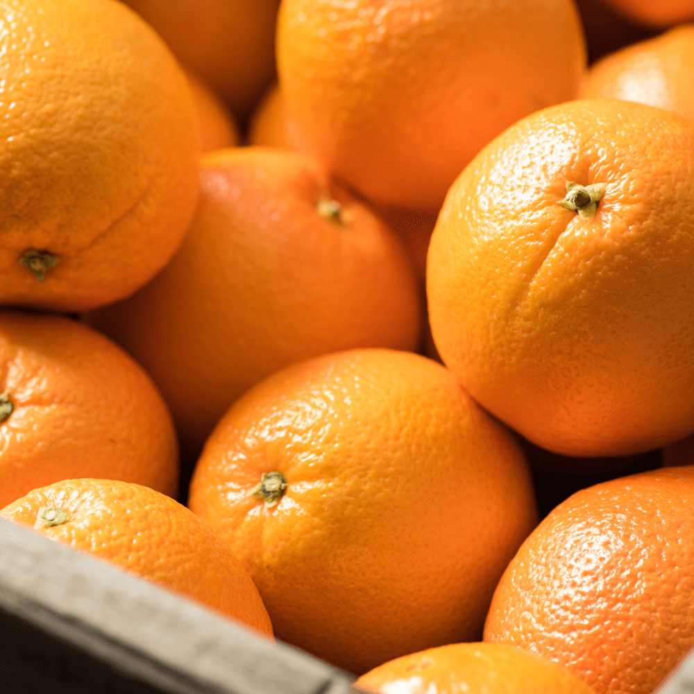 Bunch of navel oranges in wooden crate