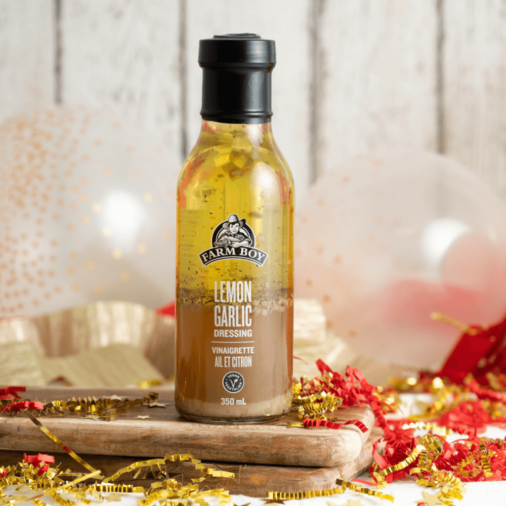 Bottle of Farm Boy Lemon Garlic Dressing with celebratory red and gold background