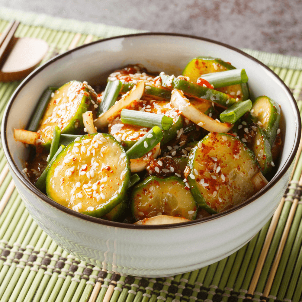Easy Spicy Korean Cucumber Salad Oi Muchim made with garlic, onion, sesame and hot peppers on the table