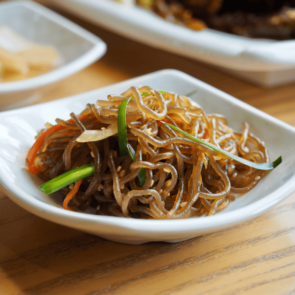 Curved plate with authentic stir fried Korean Japanese dish Japcahe