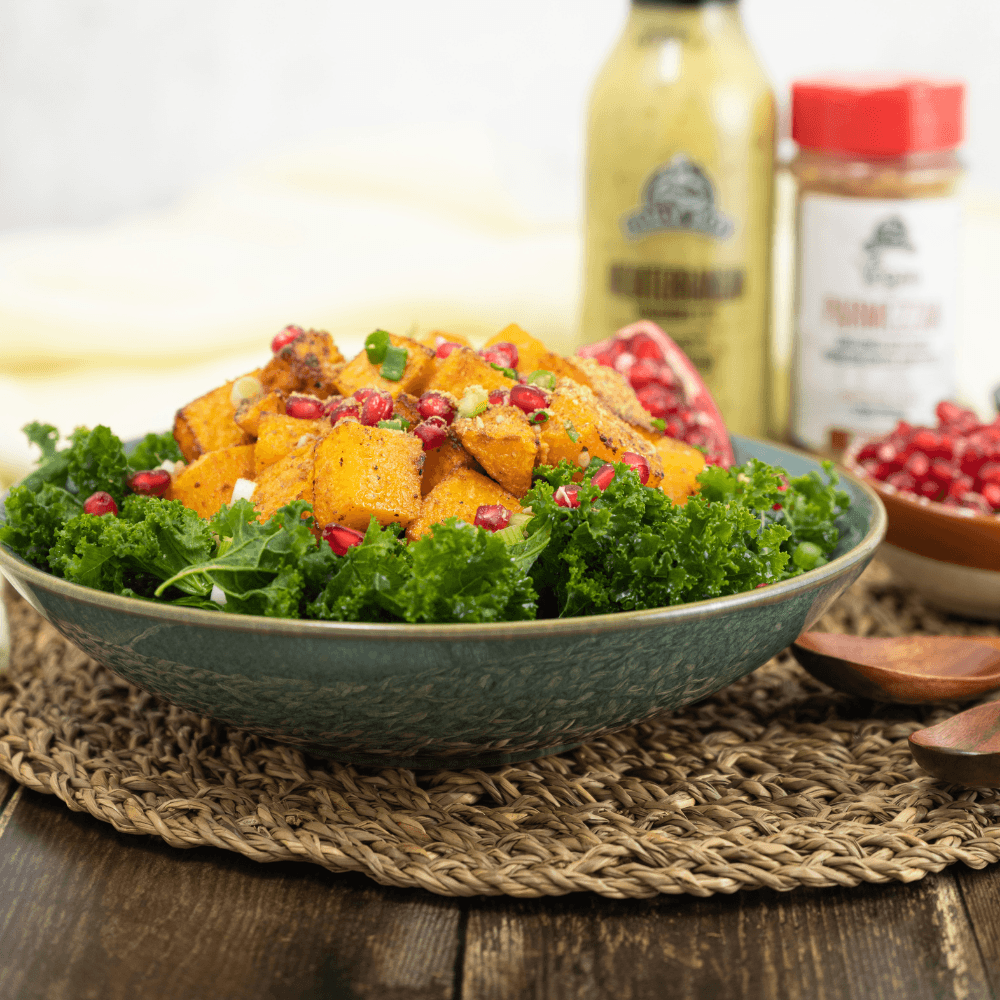 Plate of salad with kale, croutons, and pomegranate arils