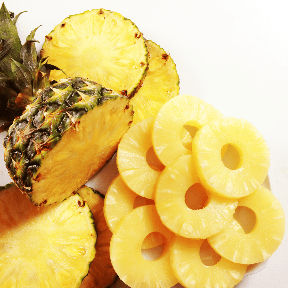 Sliced up pineapple and pineapple rings on white background