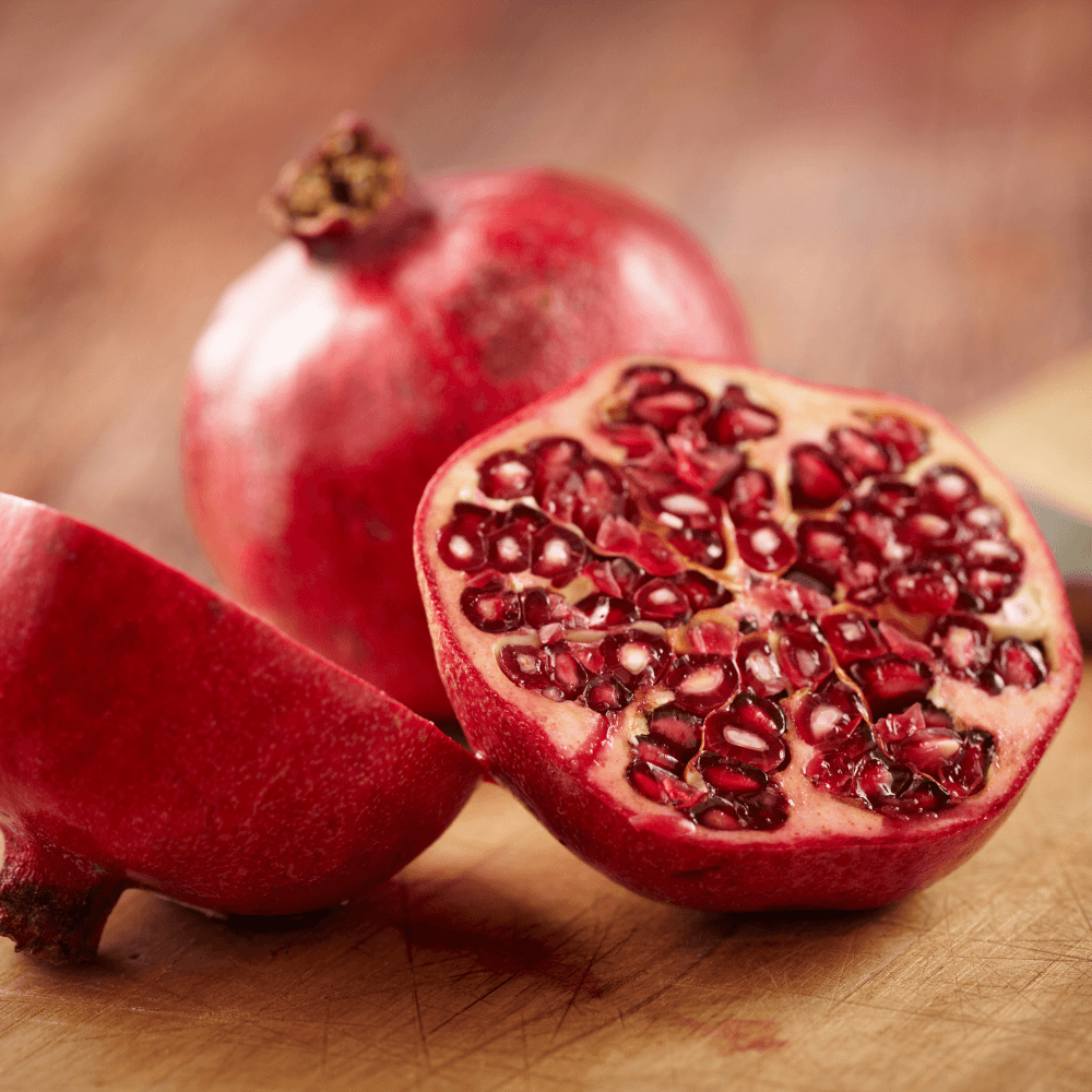 Halved pomegranate on wooden table