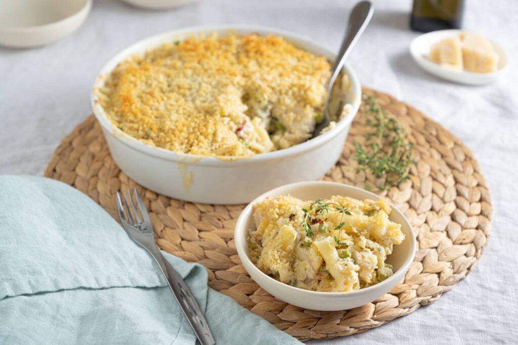 Casserole dish of chicken tetrazzini with a portion scooped out