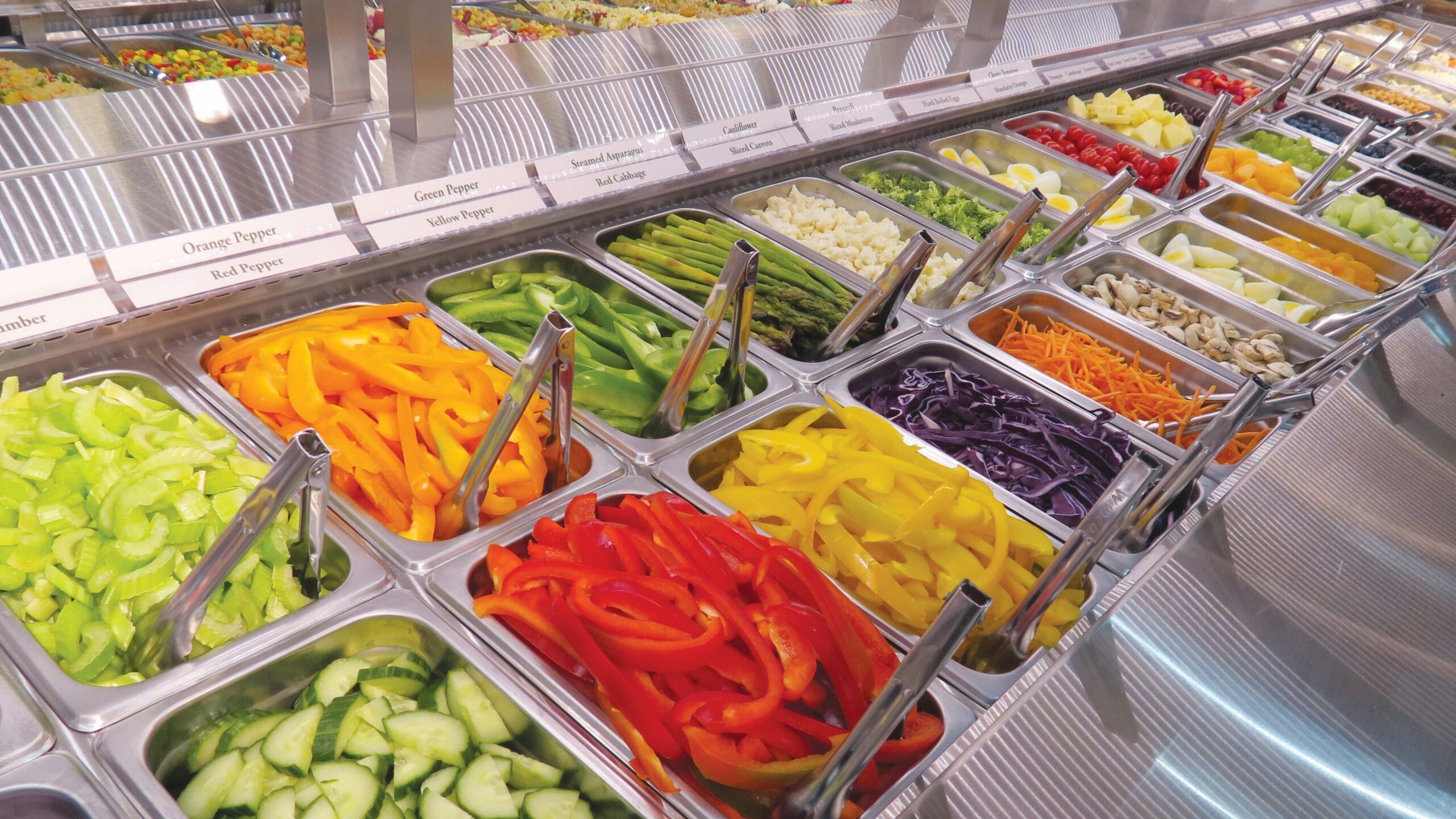 salad bar with fresh veggies in individual containers