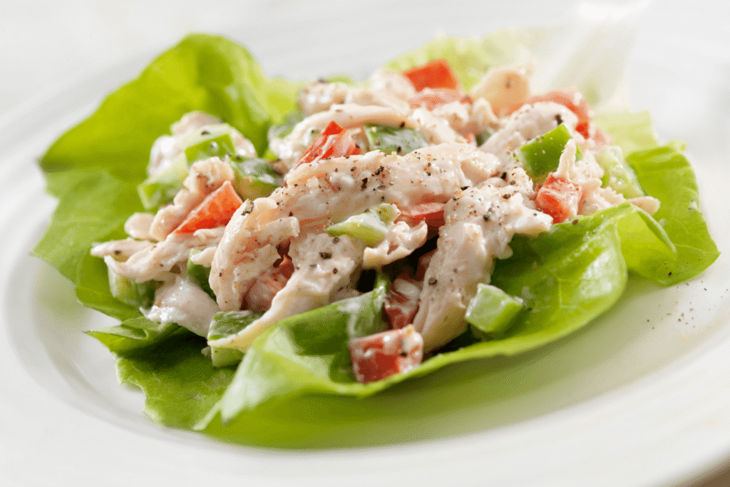 A Creamy Chicken Salad Lettuce Wrap with Red and Green Peppers