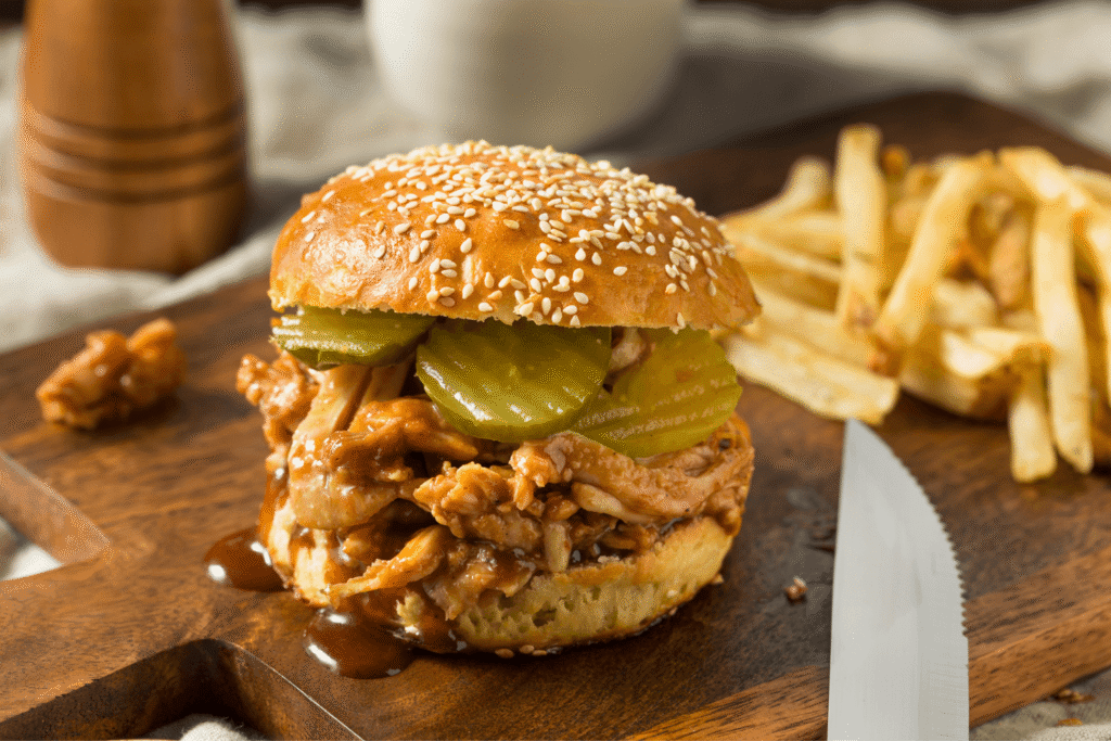 Homemade BBQ Pulled Chicken Sandwich with Pickles and Fries