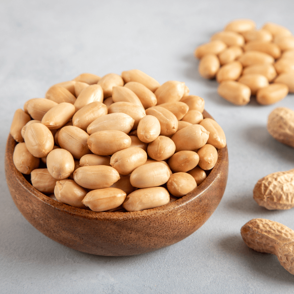 Bowl full of shelled and roasted peeled peanuts closeup