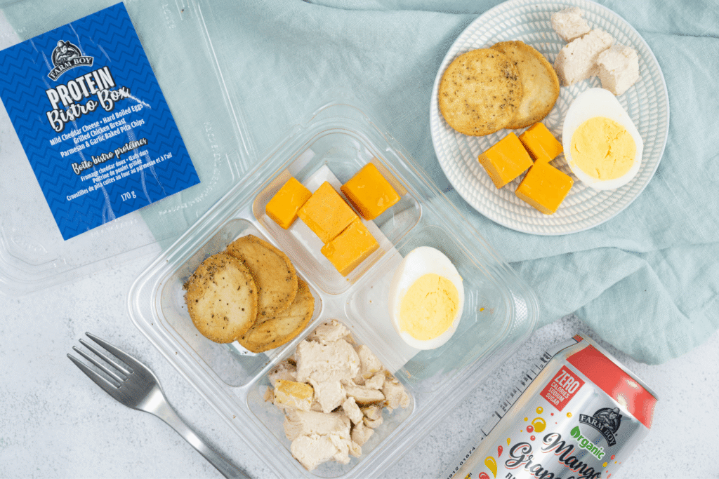 top view Farm Boy Protein Bistro Box with cheese, hard boiled eggs, crackers, and chicken