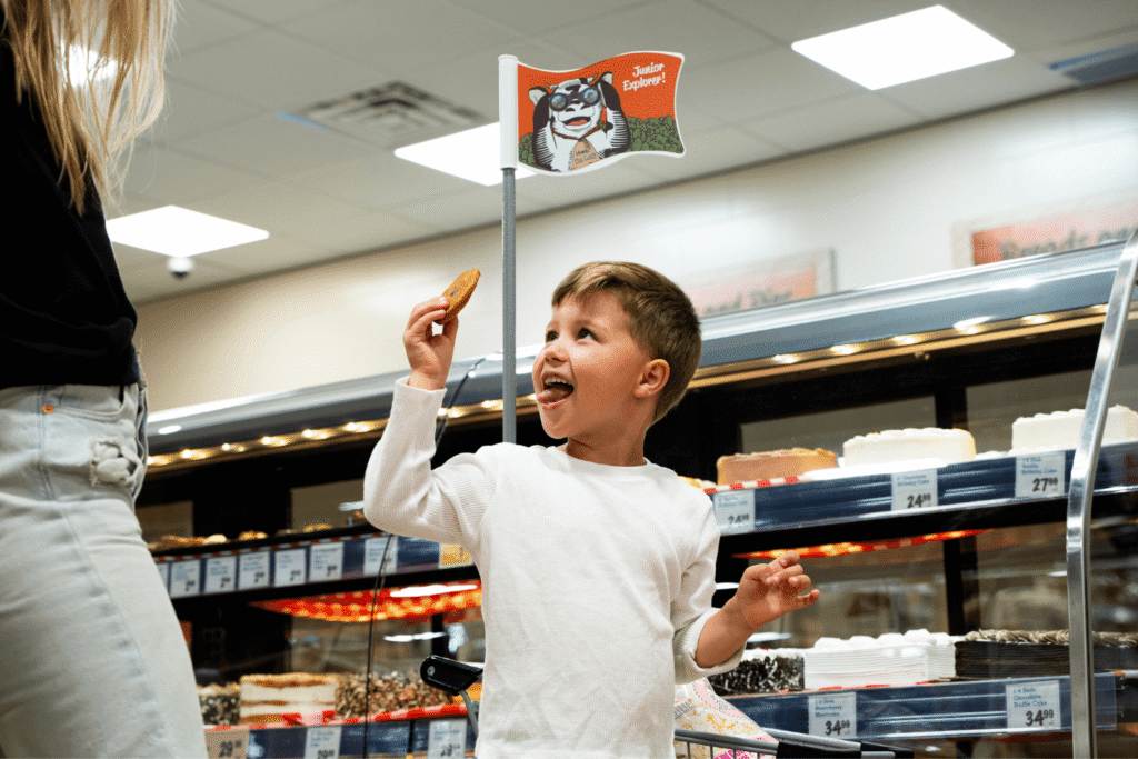 Young boy holding up a cookie in the Bake SHop at Farm Boy for family shoppers