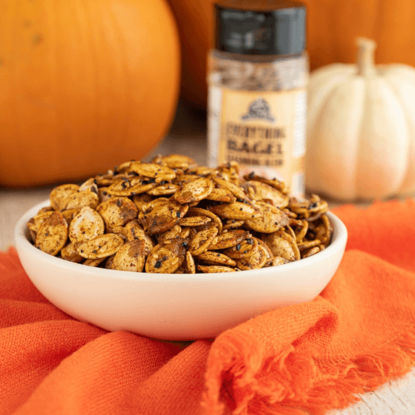 Small white bowl filled with everything bagel seasoned pumpkin seeds